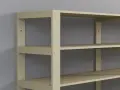 En beige hylla med flera hyllplan, monterad med konsoler mot en grå vägg. Perfekt för att bygga hylla med konsoler för förvaring.