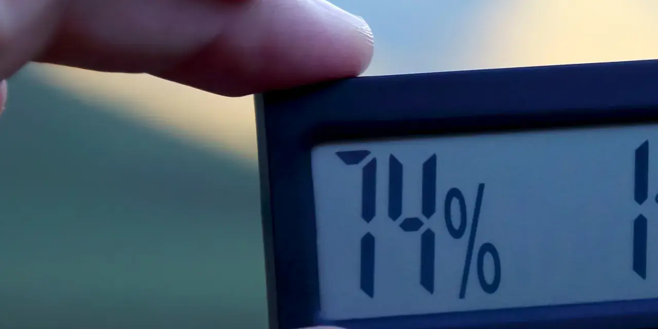 En digital hygrometer visar 74% luftfuktighet inomhus.