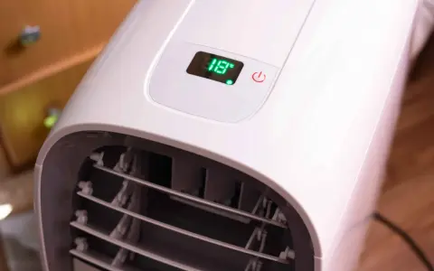 Portabel ac med slang visar 18 grader på displayen.