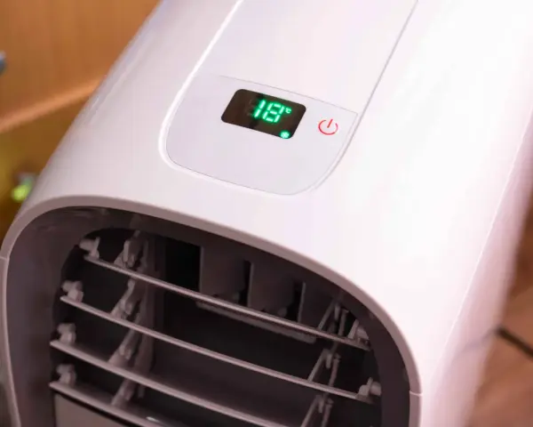 Portabel ac med slang visar 18 grader på displayen.
