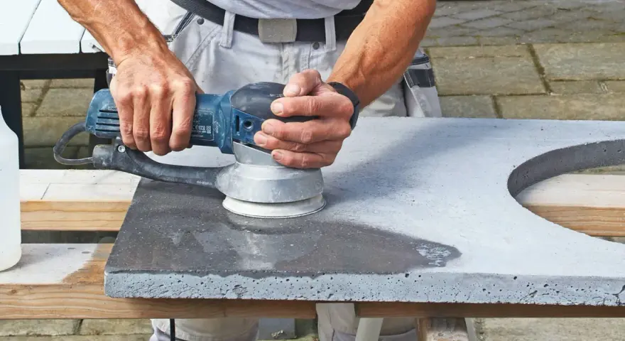 Man slipar betonggolv med en maskin.