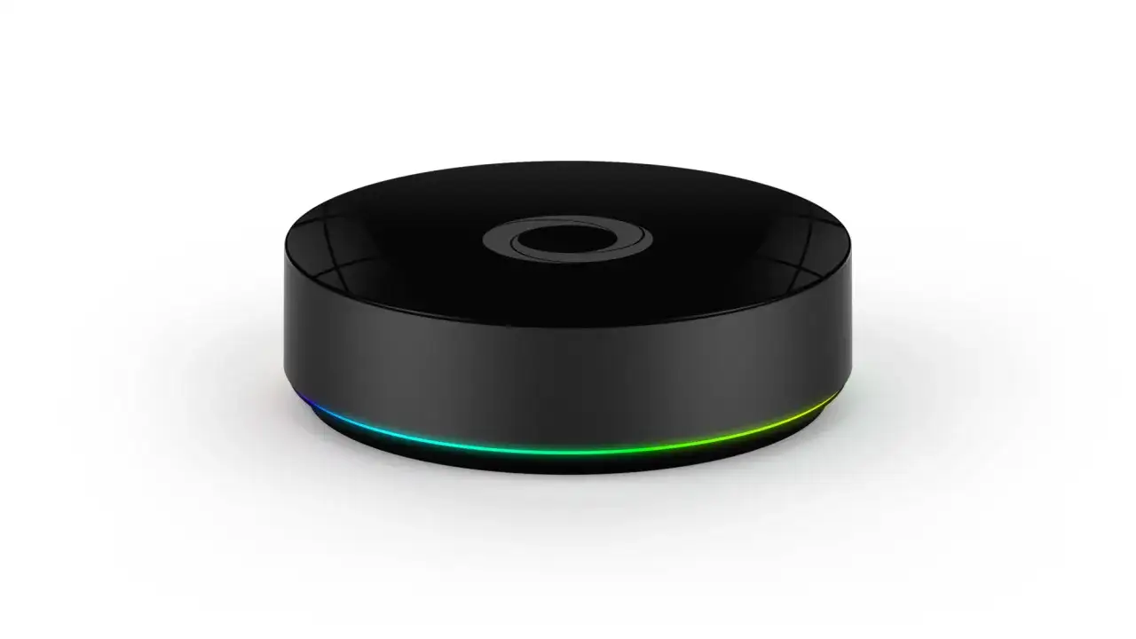 Svart, rund enhet med logotyp och färgstark LED-ring runt basen, liknande en Homey Pro 2019.